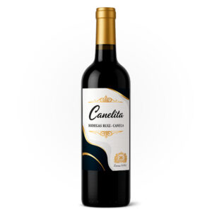Botella de vino ‘Canelita’ de Bodegas Ruiz-Canela, con etiqueta blanca decorada con motivos dorados y formas curvas sobre fondo blanco.